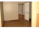Hallway featuring tile floors, neutral walls, and multiple doors, providing access to different rooms at 255 S Pennsylvania Ave, Lake Alfred, FL 33850