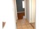 Tile flooring in the hallway leads to a room with hardwood floors at 255 S Pennsylvania Ave, Lake Alfred, FL 33850
