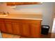 Well-organized kitchen cabinets with a convenient waste bin at 255 S Pennsylvania Ave, Lake Alfred, FL 33850