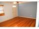 Bright living room featuring hardwood floors and a classic ceiling fan at 255 S Pennsylvania Ave, Lake Alfred, FL 33850
