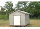 Exterior of a storage shed with a white door on a grassy lawn at 255 S Pennsylvania Ave, Lake Alfred, FL 33850