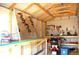 Interior shed view featuring pegboard wall and wooden shelving at 255 S Pennsylvania Ave, Lake Alfred, FL 33850