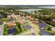 Aerial view highlighting the property's proximity to a picturesque lake and lush green surroundings at 2551 Delphi Woods Cir, Lakeland, FL 33812