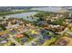 Elevated shot displaying the home's setting in a peaceful neighborhood near a scenic lake at 2551 Delphi Woods Cir, Lakeland, FL 33812