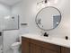 Bathroom with white counters, wooden cabinets, black fixtures, and a walk-in shower at 2551 Delphi Woods Cir, Lakeland, FL 33812