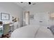 Bright bedroom featuring neutral walls, white trim, a ceiling fan, double closets, and a workspace at 2551 Delphi Woods Cir, Lakeland, FL 33812
