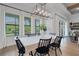 Elegant dining room with modern light fixture and large windows at 2551 Delphi Woods Cir, Lakeland, FL 33812