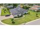 Stunning one-story home with manicured lawn, brick driveway and elegant architectural details at 2551 Delphi Woods Cir, Lakeland, FL 33812