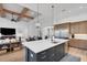 Spacious kitchen island with sink, stainless steel appliances, and open layout to living area at 2551 Delphi Woods Cir, Lakeland, FL 33812