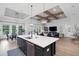 Bright, open kitchen with island and sink; view to dining and living areas at 2551 Delphi Woods Cir, Lakeland, FL 33812