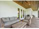 Covered patio boasting comfortable seating, a grill, and a wood ceiling at 2551 Delphi Woods Cir, Lakeland, FL 33812