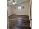 Bright bedroom with vaulted ceilings, ceiling fan, wood-look flooring, and natural light at 2621 Island Oaks W, Lakeland, FL 33805