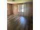 Wood paneled bedroom with wood-look flooring and natural lighting at 2621 Island Oaks W, Lakeland, FL 33805