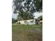 Charming single-story home with a well-maintained front yard and welcoming entryway with steps at 2621 Island Oaks W, Lakeland, FL 33805