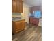 Functional kitchen with wood cabinets, laminate countertops, and neutral walls at 2621 Island Oaks W, Lakeland, FL 33805