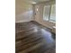 Inviting living room with wood-look floors, white trim, and natural lighting at 2621 Island Oaks W, Lakeland, FL 33805