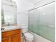 Well-maintained bathroom featuring a shower-tub combination with sliding glass doors at 2660 Hemingway Ave, Haines City, FL 33844