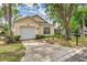 Charming single-story home featuring an attached garage and a well-manicured front yard at 2660 Hemingway Ave, Haines City, FL 33844