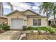 A quaint single-story home displaying a bright exterior, attached garage, and manicured landscaping at 2660 Hemingway Ave, Haines City, FL 33844