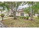 Inviting single-story home showcasing mature trees, manicured landscaping, and a cozy, well-kept front yard at 2660 Hemingway Ave, Haines City, FL 33844