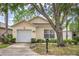 Charming single-story home with an attached garage, well-maintained lawn, and inviting curb appeal at 2660 Hemingway Ave, Haines City, FL 33844