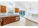 Well-equipped kitchen with a modern dishwasher, wooden cabinetry, and bar top, ideal for meal prep at 2660 Hemingway Ave, Haines City, FL 33844