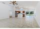 Open-concept living room flowing into the kitchen, featuring tile floors and a view of the pool at 2660 Hemingway Ave, Haines City, FL 33844