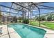 Sparkling pool with screened enclosure, offering outdoor enjoyment and views of a golf course at 2660 Hemingway Ave, Haines City, FL 33844
