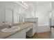 Well lit bathroom has double sinks, large mirror, and combination tub and shower at 2812 Hickory Ridge Dr, Lakeland, FL 33813