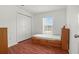 Bedroom features wood floors, closet, and window with blind offering natural light at 2812 Hickory Ridge Dr, Lakeland, FL 33813