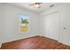 Bedroom features wood floors, a closet and a window providing natural light at 2812 Hickory Ridge Dr, Lakeland, FL 33813