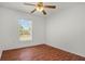 Bright bedroom features a ceiling fan, wood floors and a large window for natural light at 2812 Hickory Ridge Dr, Lakeland, FL 33813