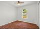 Cozy bedroom features neutral walls, wood floors, and a window offering natural light at 2812 Hickory Ridge Dr, Lakeland, FL 33813