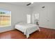 Bright bedroom has wood floors, ceiling fan, window and access to bathroom at 2812 Hickory Ridge Dr, Lakeland, FL 33813
