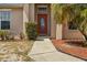 Welcoming front entrance with a red door and manicured bushes, creating a warm curb appeal at 2812 Hickory Ridge Dr, Lakeland, FL 33813