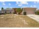 Charming single-story home with a two-car garage, complemented by a palm tree in the front yard at 2812 Hickory Ridge Dr, Lakeland, FL 33813