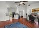 Open-concept living room features wood floors, ceiling fan, breakfast bar, and opens to a bedroom at 2812 Hickory Ridge Dr, Lakeland, FL 33813