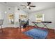 Bright, spacious living room with wood floors, a ceiling fan, and ample natural light from large windows at 2812 Hickory Ridge Dr, Lakeland, FL 33813