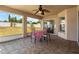 A shaded patio with stone floors features a table set for four, perfect for outdoor dining at 2812 Hickory Ridge Dr, Lakeland, FL 33813