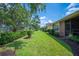 Lush backyard with well-manicured lawn, mature trees, and views of neighboring properties at 2965 Mission Lakes Dr, Lakeland, FL 33803