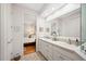 Bright bathroom with double vanity, white cabinets, and access to the main bedroom at 2965 Mission Lakes Dr, Lakeland, FL 33803