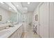 Bright bathroom with a large mirror, double sinks, and a glass-enclosed shower at 2965 Mission Lakes Dr, Lakeland, FL 33803
