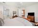 Comfortable bedroom with an ensuite bathroom, classic furniture and wood flooring at 2965 Mission Lakes Dr, Lakeland, FL 33803