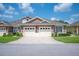 Inviting townhome featuring a well-manicured lawn and convenient two-car garage at 2965 Mission Lakes Dr, Lakeland, FL 33803