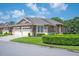 Charming single-story home features a well-manicured lawn and attached two-car garage at 2965 Mission Lakes Dr, Lakeland, FL 33803