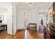 Bright foyer with hardwood floors, a bench, and a decorative light fixture at 2965 Mission Lakes Dr, Lakeland, FL 33803