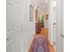 Charming hallway with decorative rug and hardwood floors with access to other rooms at 2965 Mission Lakes Dr, Lakeland, FL 33803