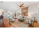 Inviting living room featuring a ceiling fan, elegant furnishings, and a decorative tapestry at 2965 Mission Lakes Dr, Lakeland, FL 33803