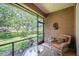 Cozy screened patio with seating and peaceful views of the landscaped backyard and greenery at 2965 Mission Lakes Dr, Lakeland, FL 33803