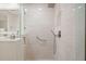 Modern walk-in shower featuring sleek, bright tiling and minimalist fixtures at 2965 Mission Lakes Dr, Lakeland, FL 33803